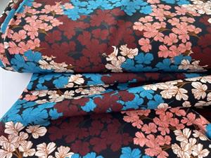 Fastvævet polyester - blomster i fine farver på sort bund