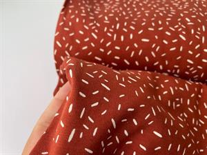 Bomuldsjersey - terracotta med offwhite mønster 