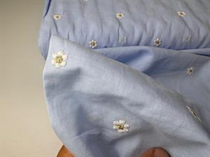 Fastvævet bomuldsvoile - små fine brodererede blomster på lyseblå bund