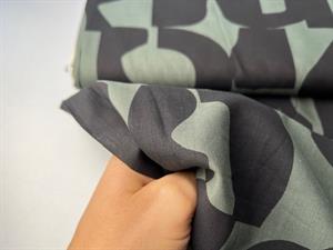 Fastvævet bomuldsvoile - mørkegrøn med sorte motiver