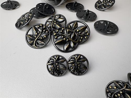 Fransk knap - sort/guld i filigran bladmønster 